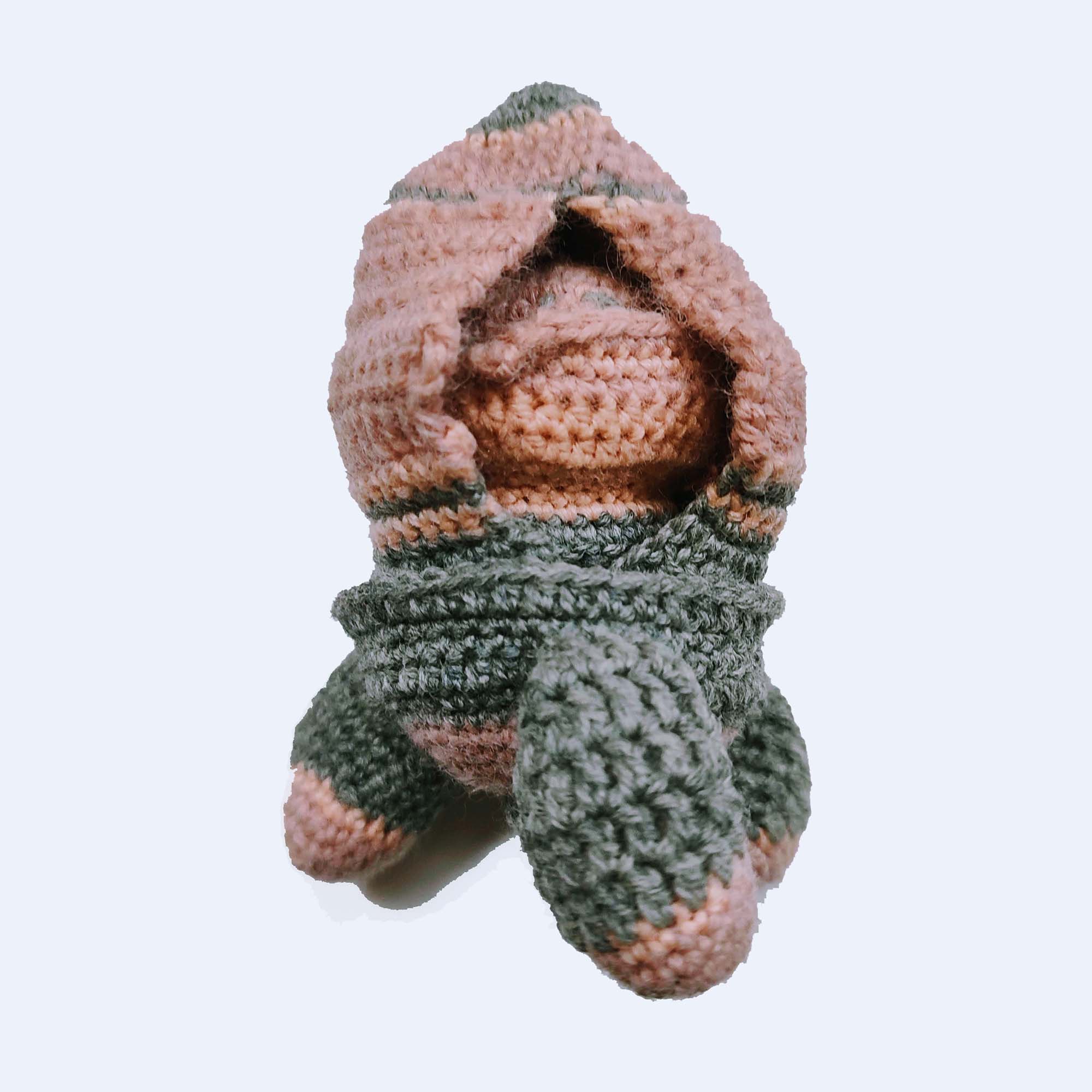 cookies and cream-colored crocheted toy bun alien hidden in rocket ship
