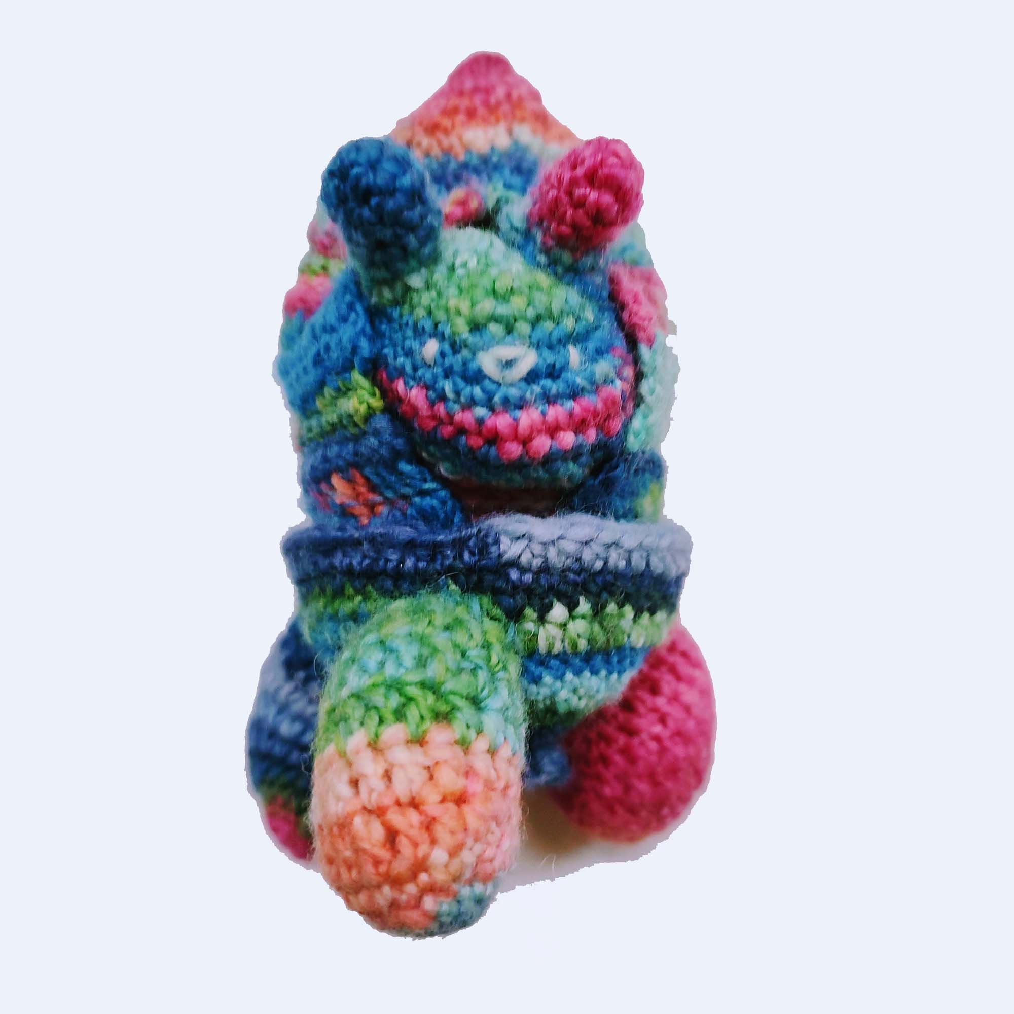 rainbow-colored crocheted toy bun alien rocket ship with ears popping out