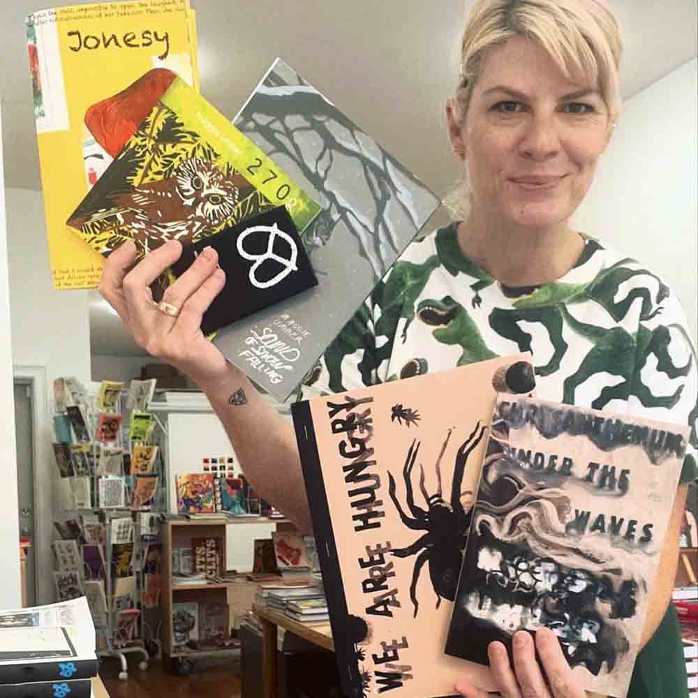 Gina Dawson holds up all my comics she ordered for Partners and Son in Philadelphia, PA