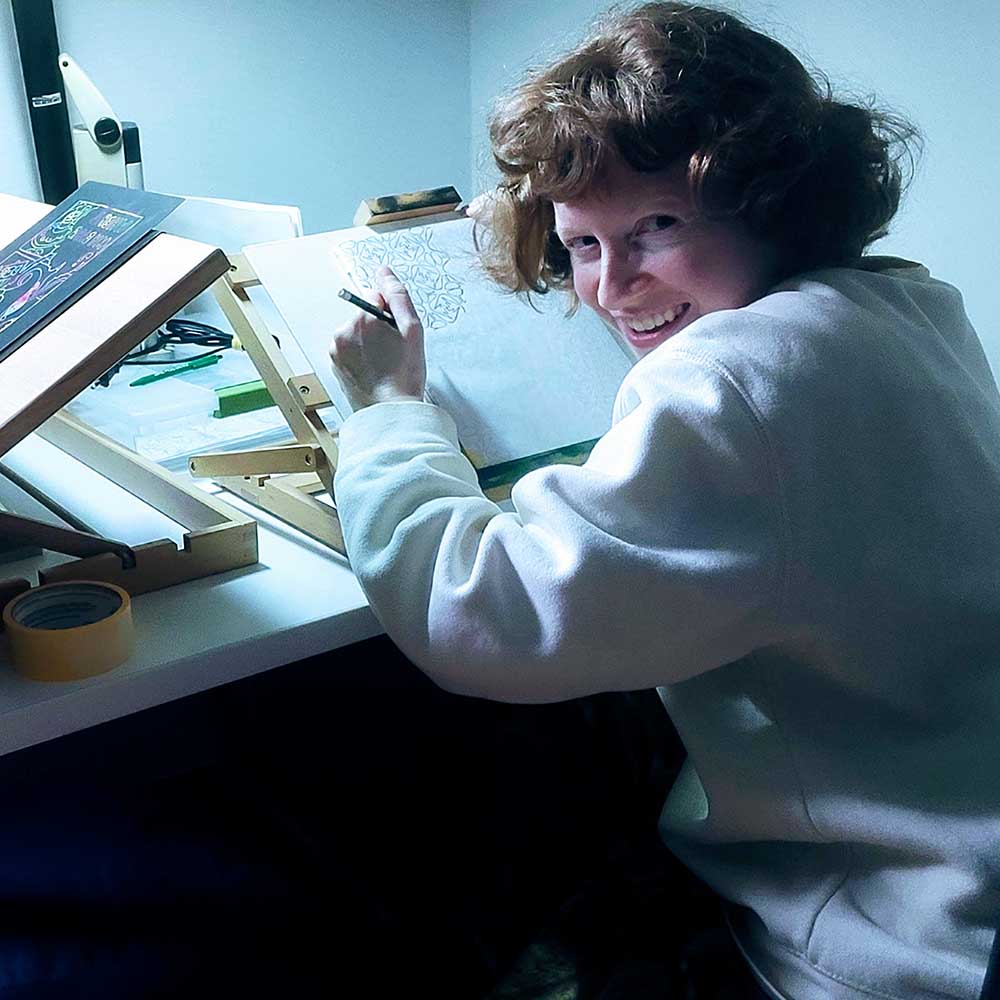 Maggie Umber at her drawing table working on the endpapers for Chrysanthemum Under the Waves